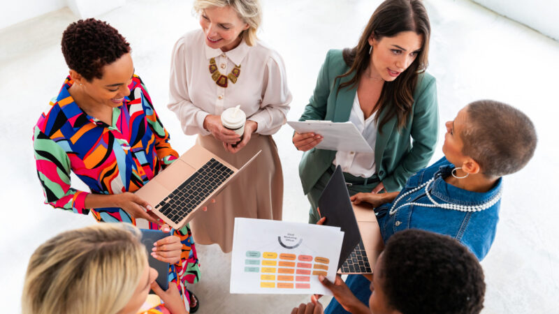 Group of beautiful confident businesswomen meeting in the office - Multiethinc female creative team brainstorming at work - Diverse colleagues working together  in workshop  in a co-working space